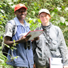 Dr Amanda Korstjens pictured right with her assistant in Kibale, Uganda