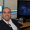 Christos Gatzidis in front of a TV showing Call of Duty 4