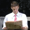 Business trader reading a newspaper