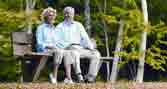 Two older people sitting on a bench