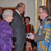 Vice-Chancellor, Professor John Vinney receiving the award from Her Majesty the Queen and The Duke of Edinburgh