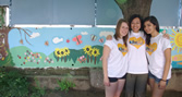 BU students in Bulgaria by a wall mural they painted