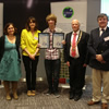 Sam Cook (centre) with his award and BU’s Dr Esteban (second left)